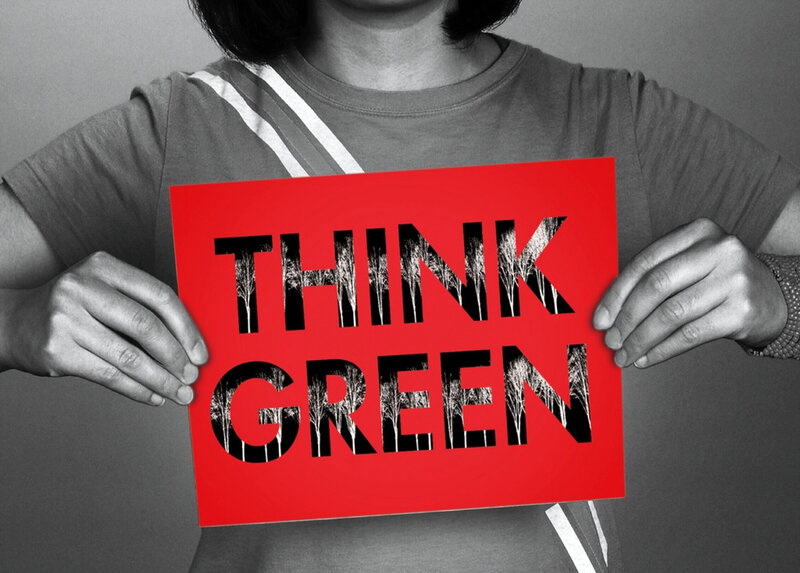 person holding think green sign