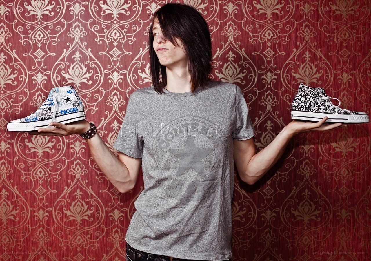 person holding two sneakers