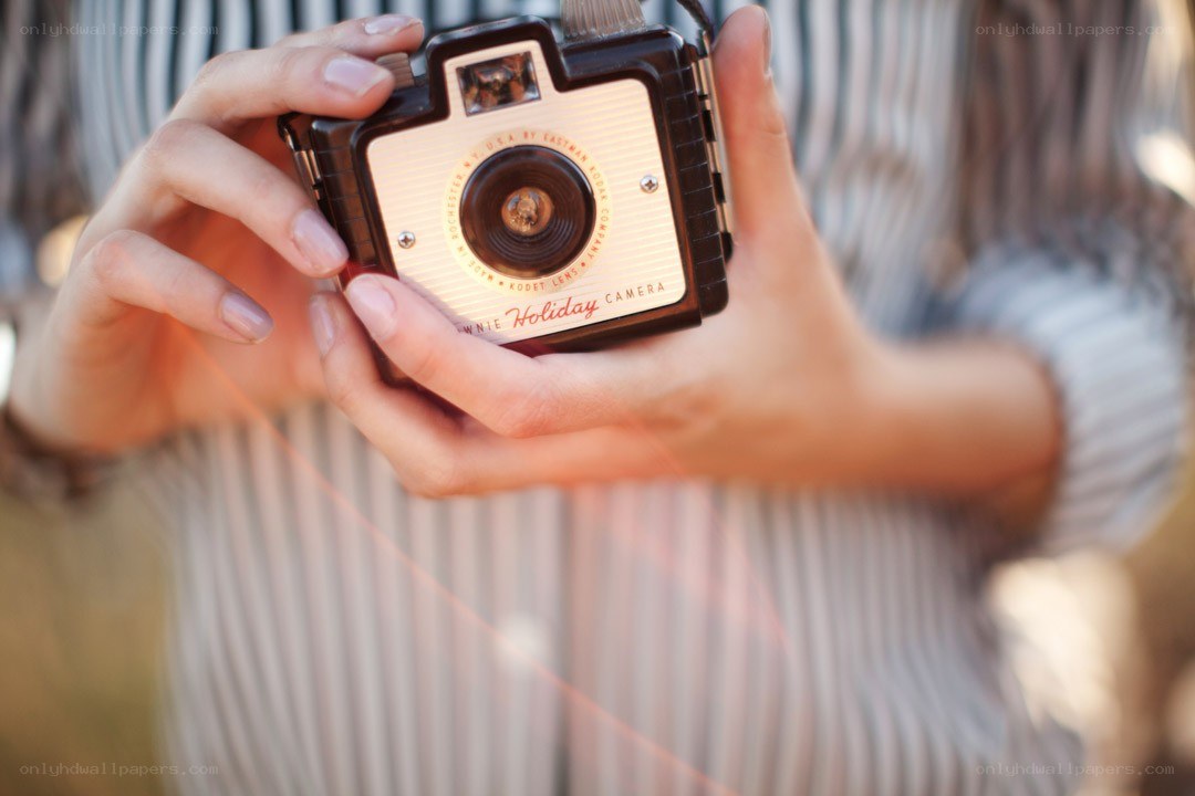 person holding vintage camera