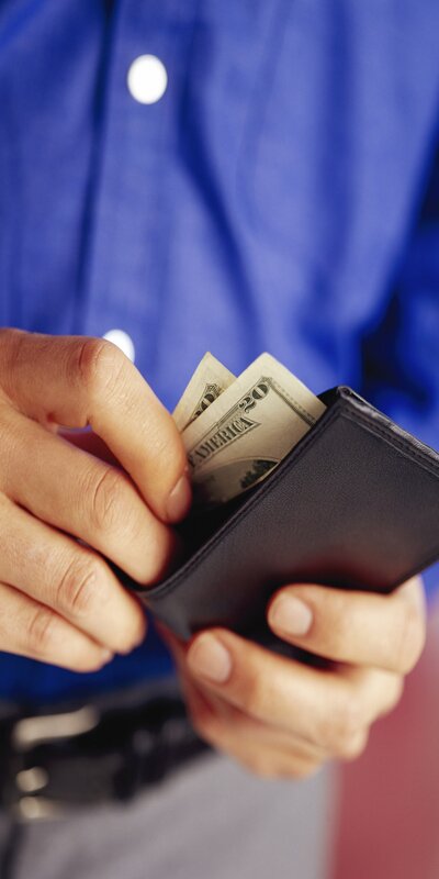 person holding wallet with money