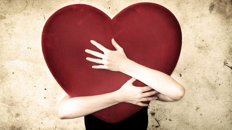 Person Hugging Heart — Red
