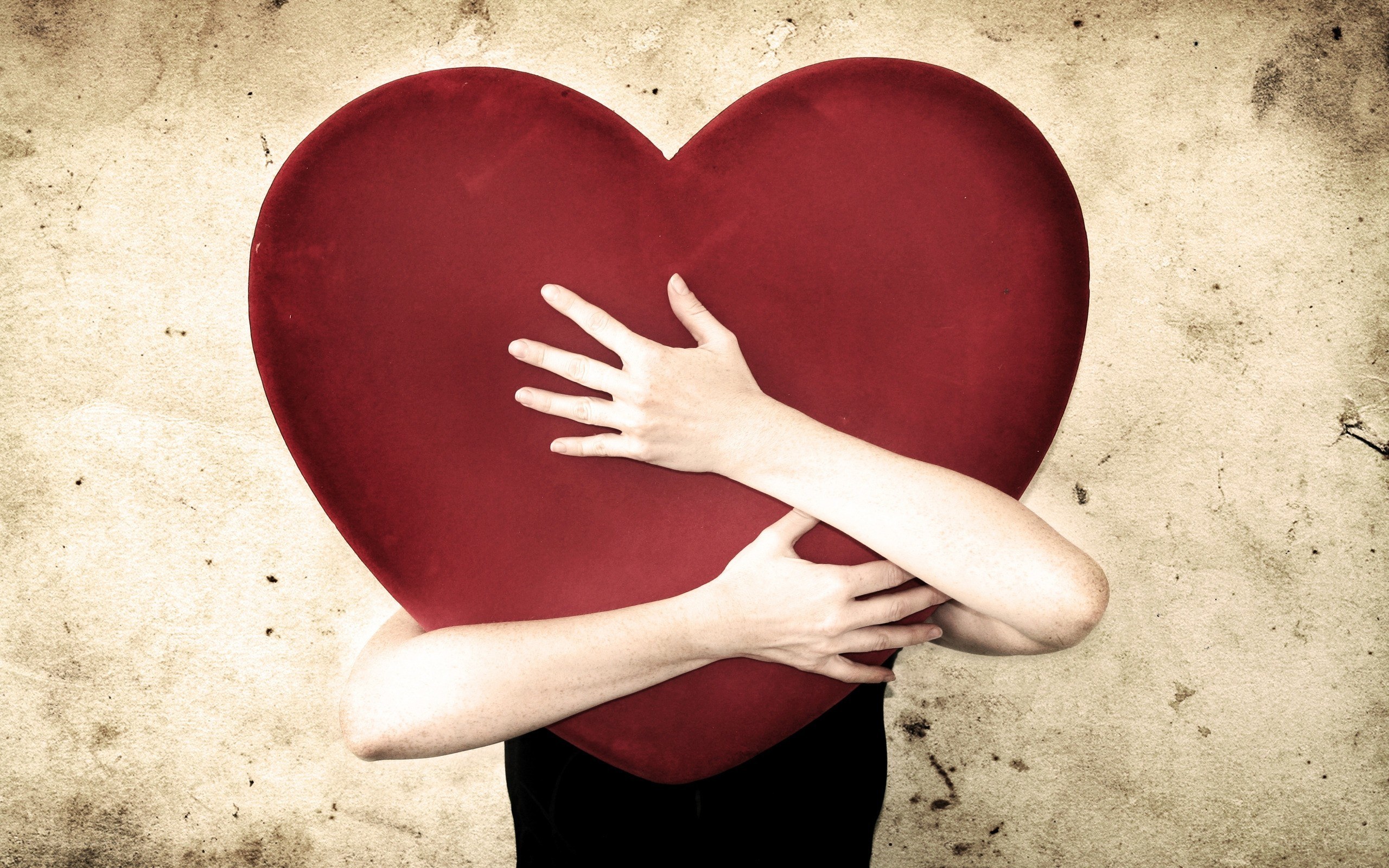 person hugging red heart