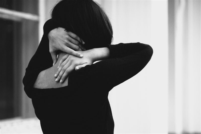 Person Hugging Themselves