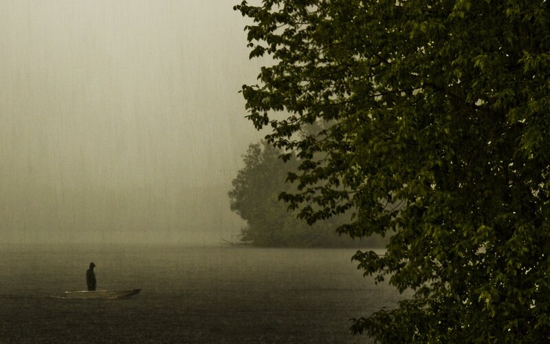 Person in a boat during rain