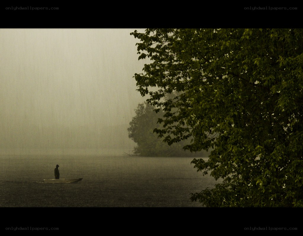 Person in a boat during rain