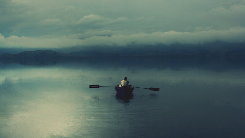 person in a boat on calm water
