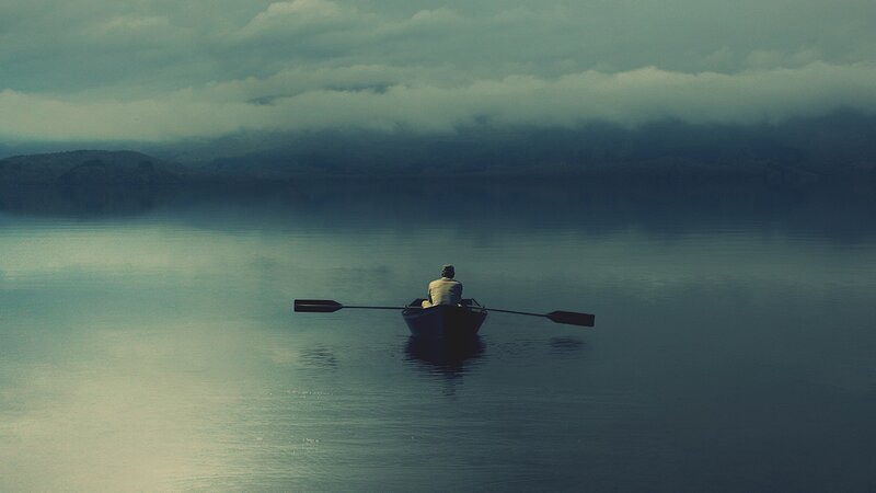 person in a boat on calm water