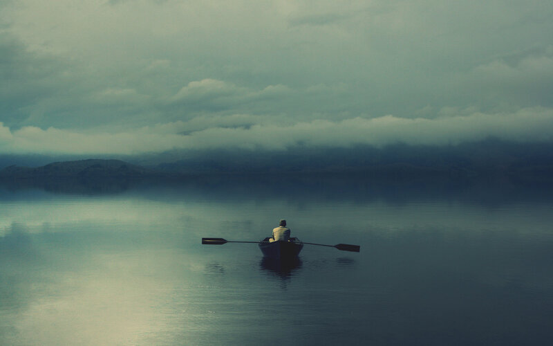 person in a boat on calm water