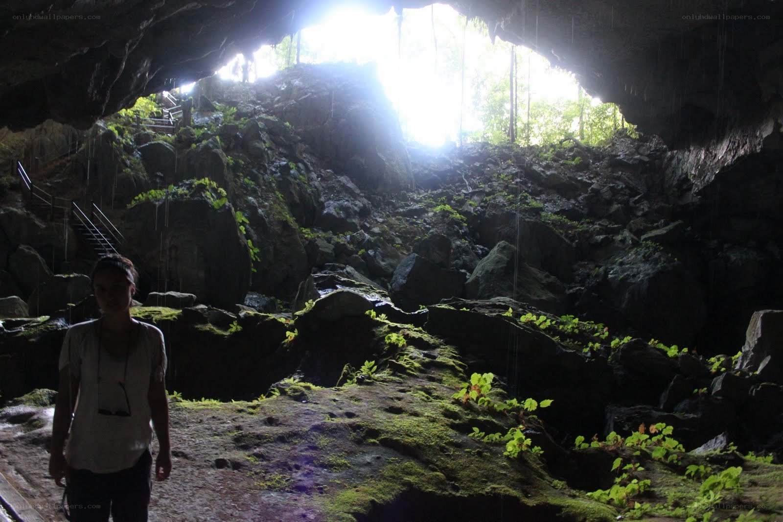 person in a cave with sunlight