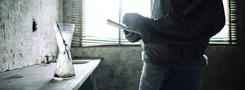 person in a dim room with glass