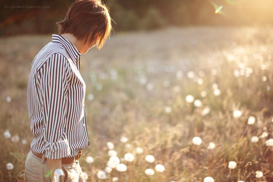person in a field at sunset