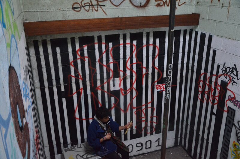 person in a graffiti-covered corner