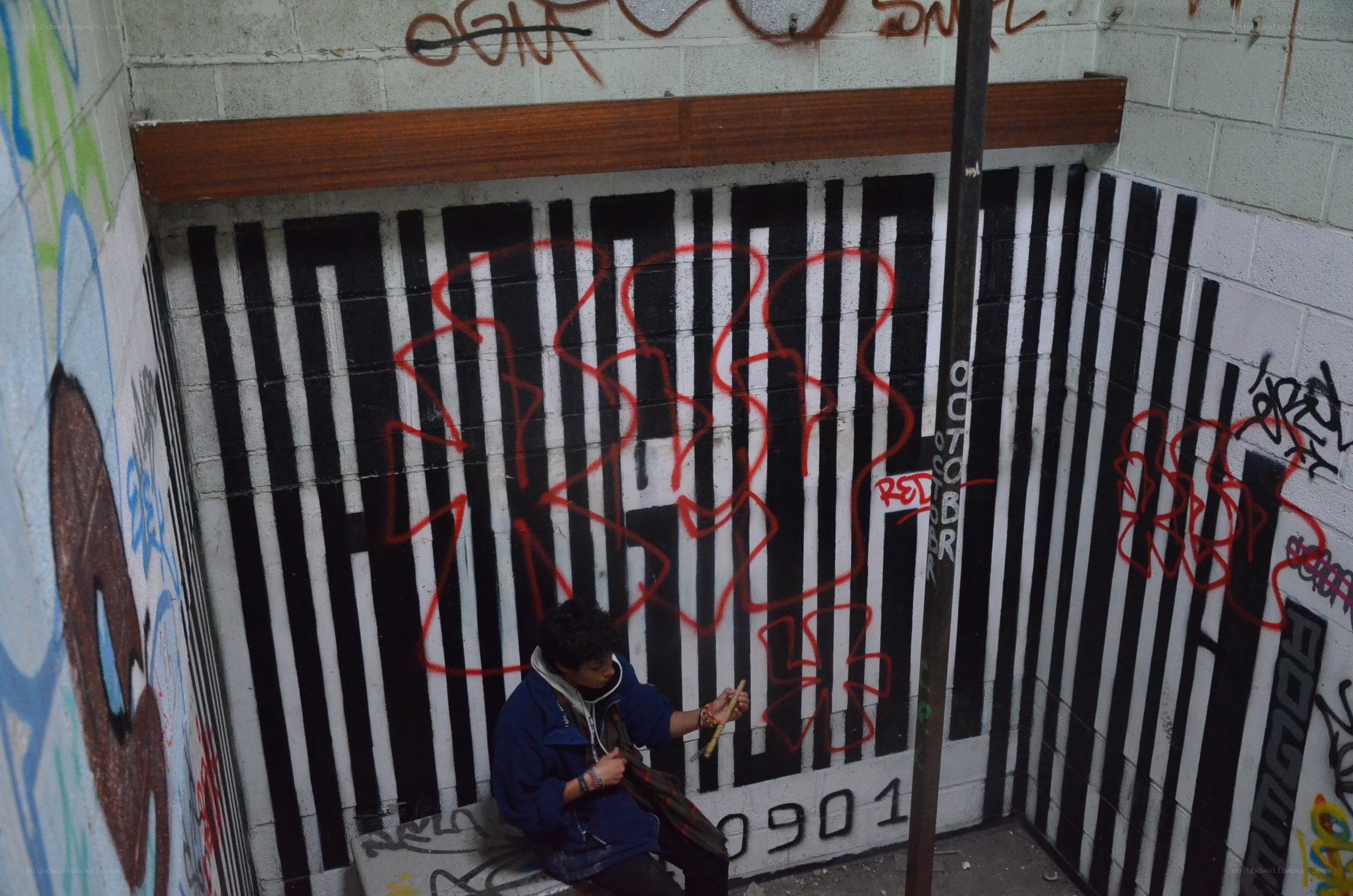 person in a graffiti-covered corner