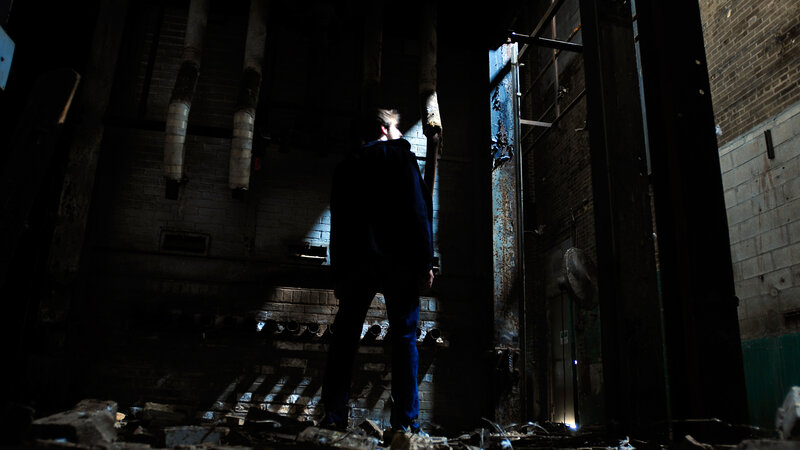 person in abandoned industrial space