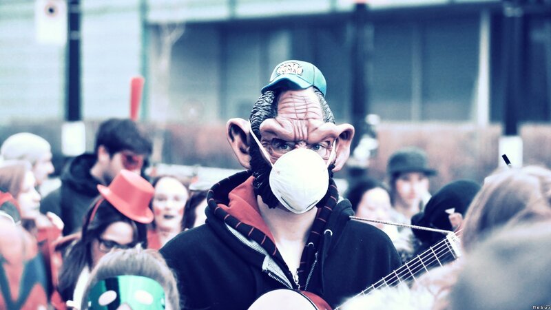 person in alien mask at festival
