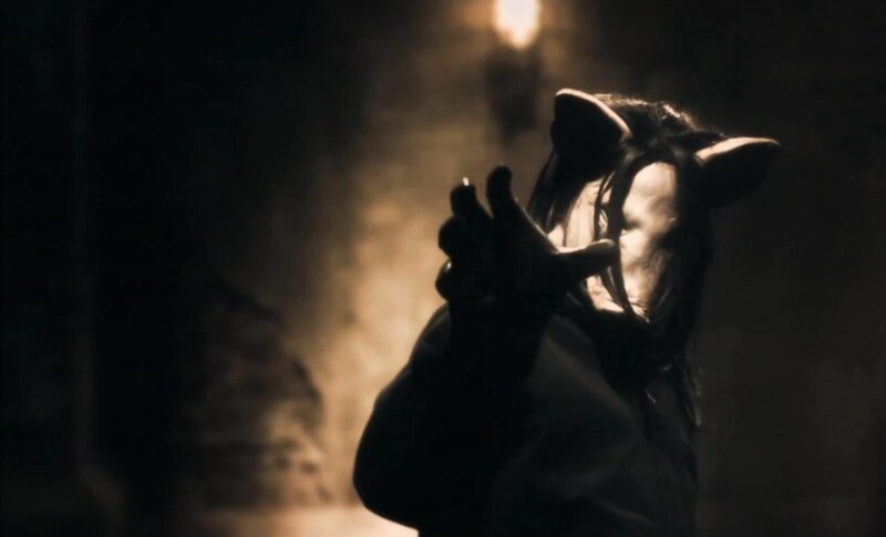 person in animal mask reaching out