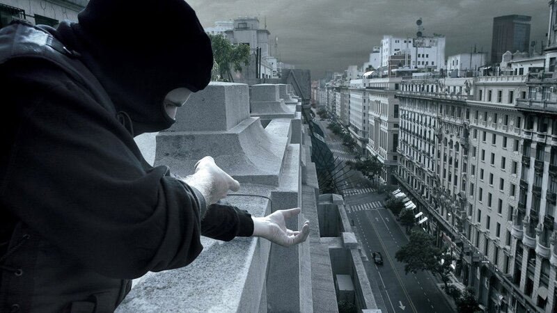 Person in Balaclava on Rooftop
