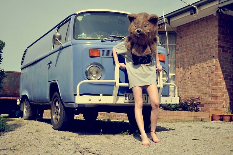 person in bear costume by van