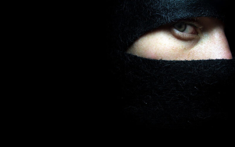 person in black balaclava