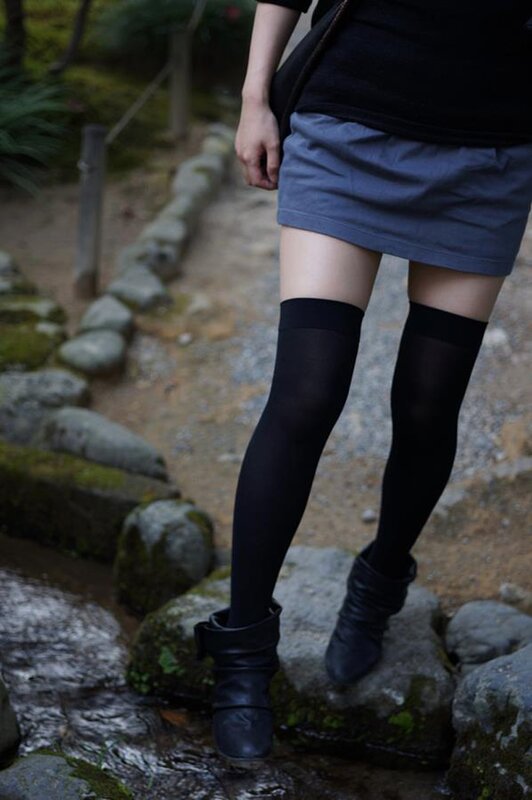 person in black boots and tights