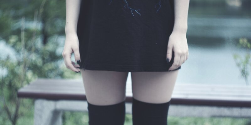 person in black dress standing