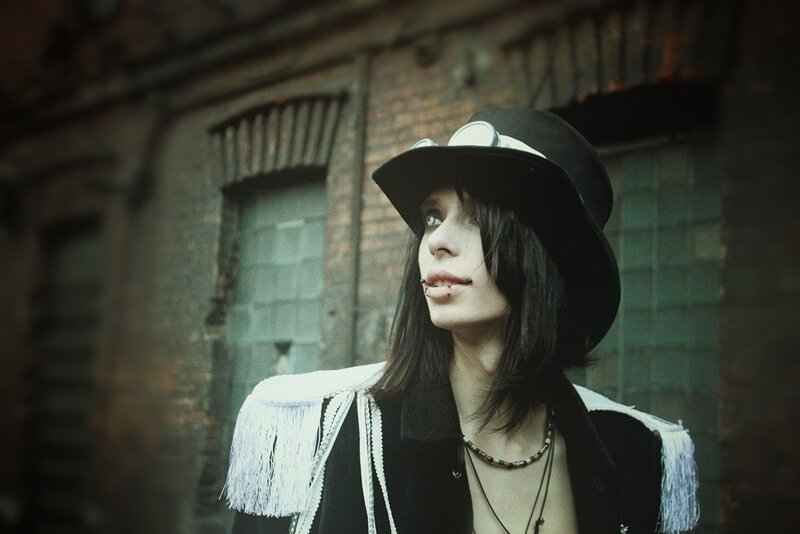 person in black hat with white fringe