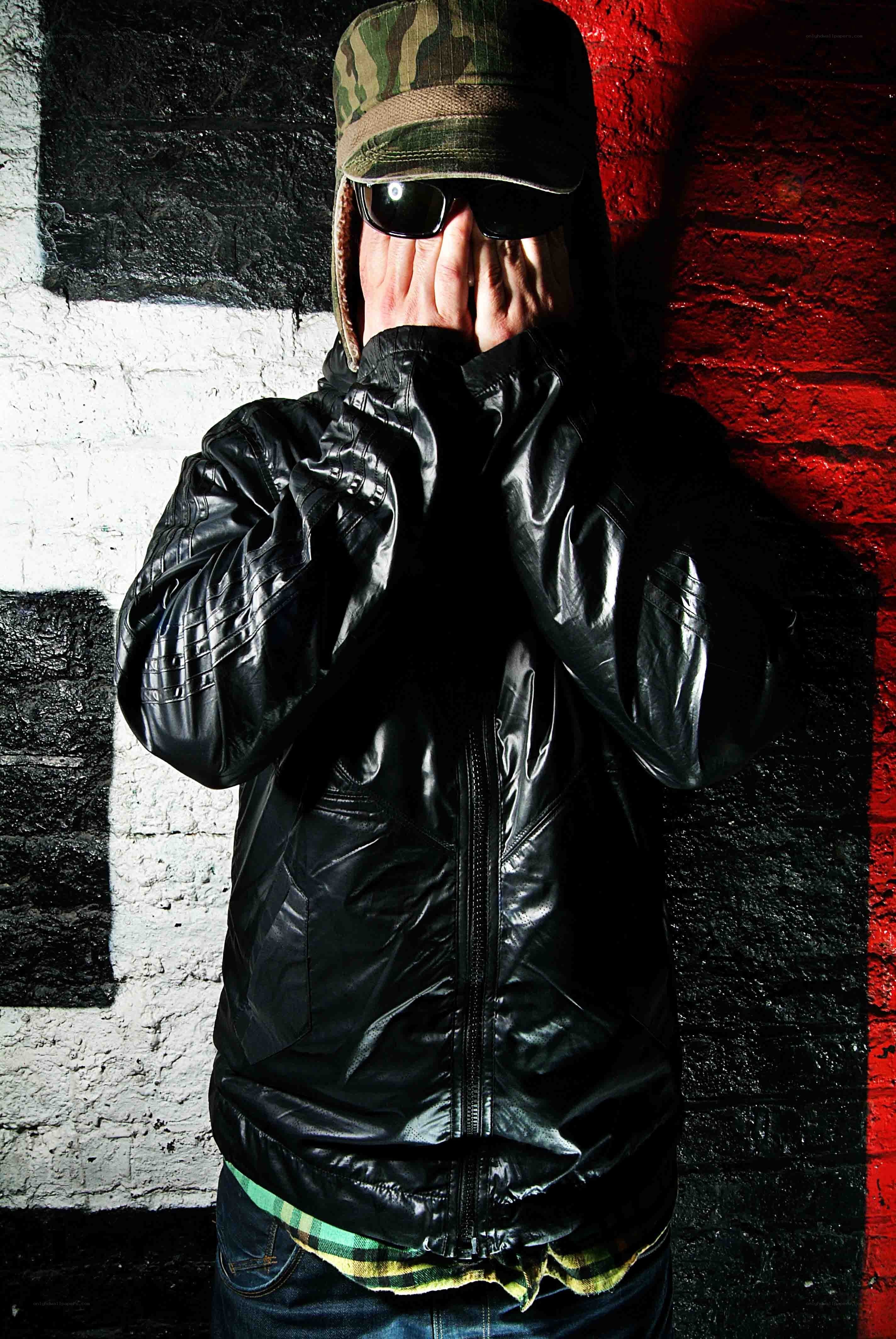 person in black jacket covering face