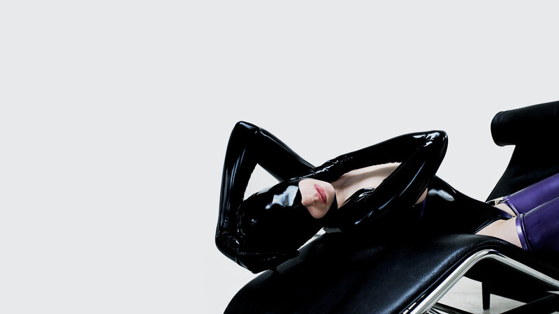 person in black latex costume