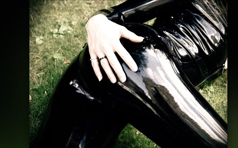 person in black latex outfit