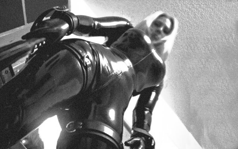 person in black latex suit