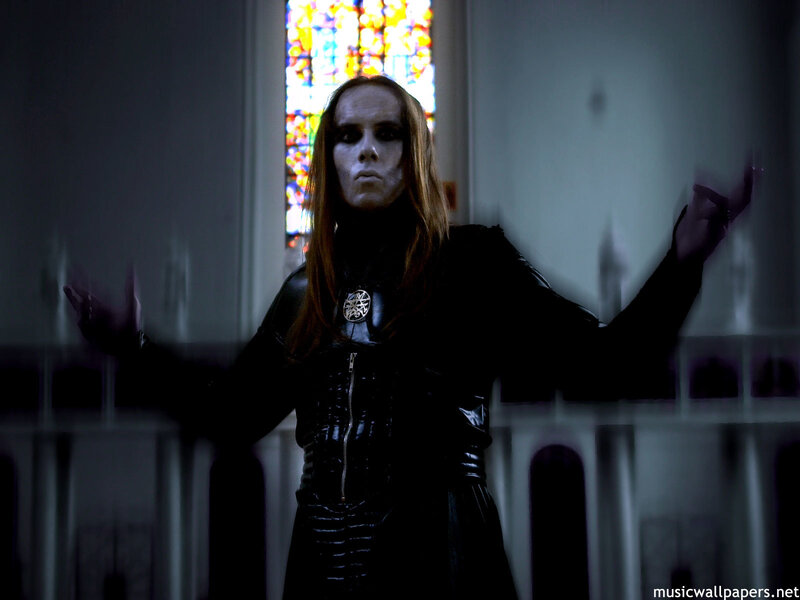 person in black leather with stained glass