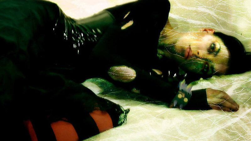 person in black outfit lying down