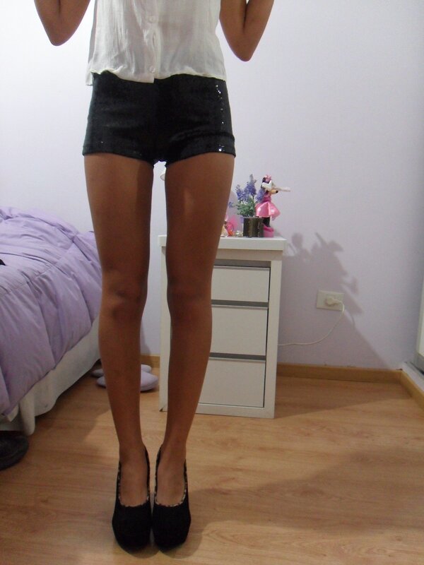 person in black shorts and heels