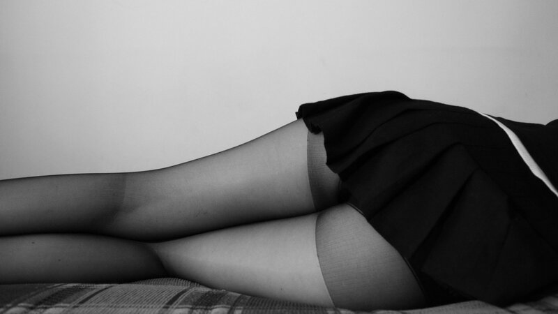 person in black skirt lying down