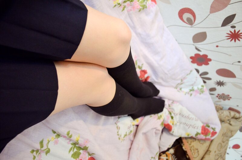 person in black socks and skirt