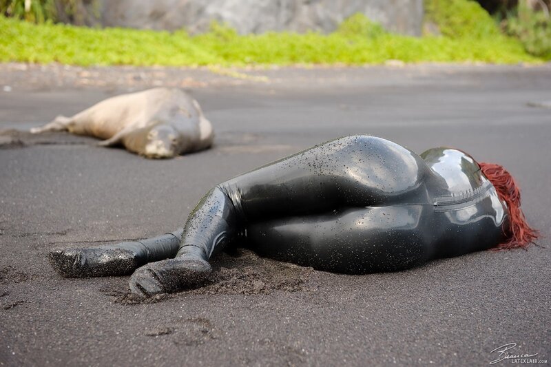 Person in black suit on beach