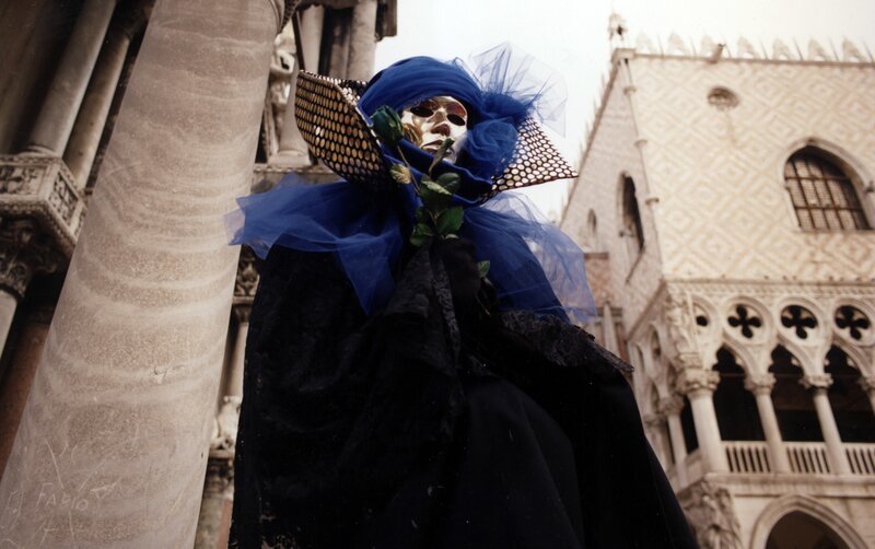 person in blue carnival mask
