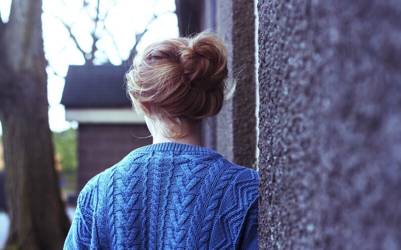 person in blue sweater from behind