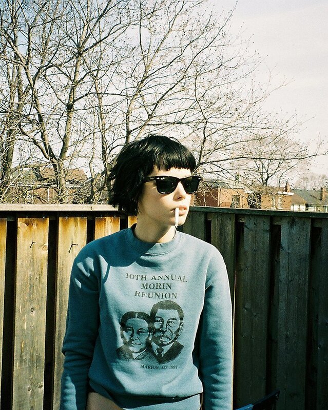 Person in blue sweatshirt outdoors