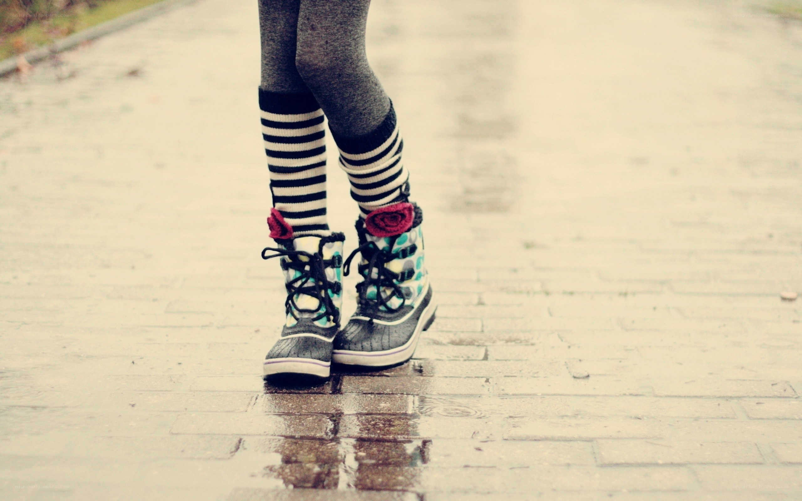 person in boots on wet pavement