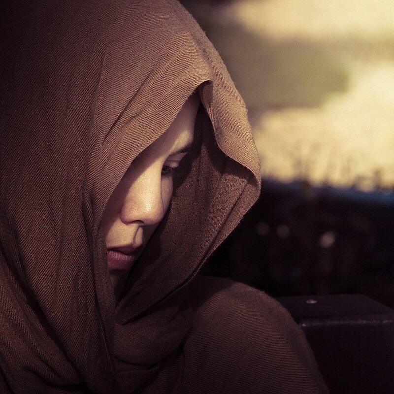 person in brown hooded garment