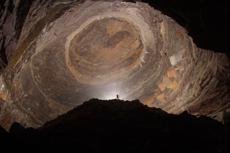Person in Cave — Brown, Dramatic, Photograph