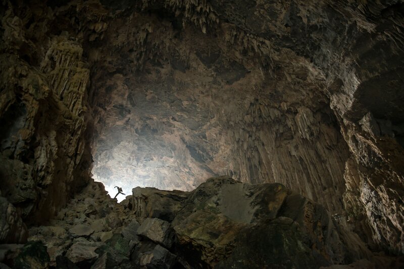 Person in Cave Entrance — Brown, Dramatic, Photograph