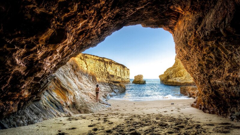 Person in Cave Entrance — Brown, Serene