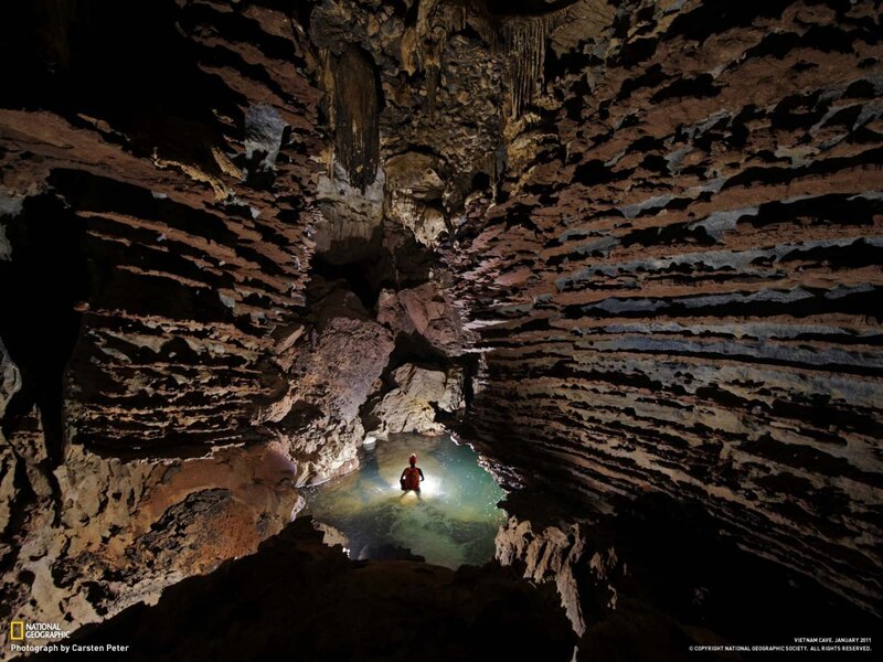 Person in Cave Pool — Brown, Dramatic