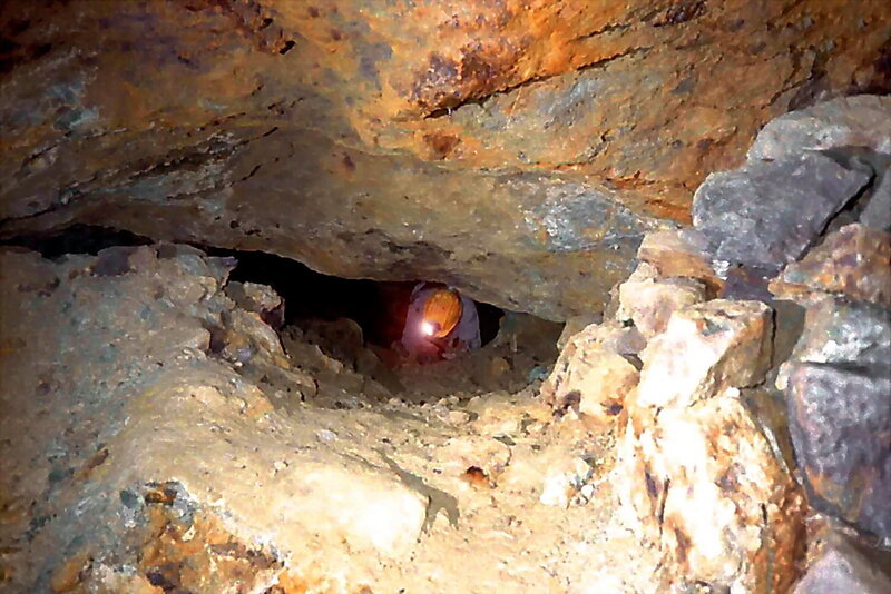 Person in Cave Tunnel — Brown