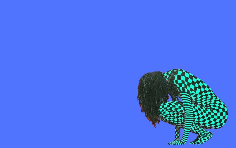 person in checkered suit crouching