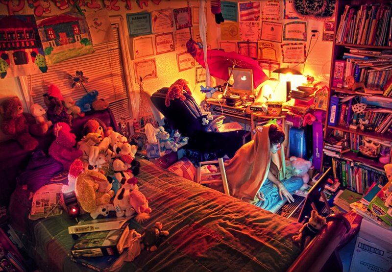 person in cluttered bedroom