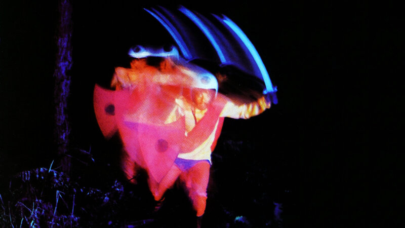 person in colorful costume at night