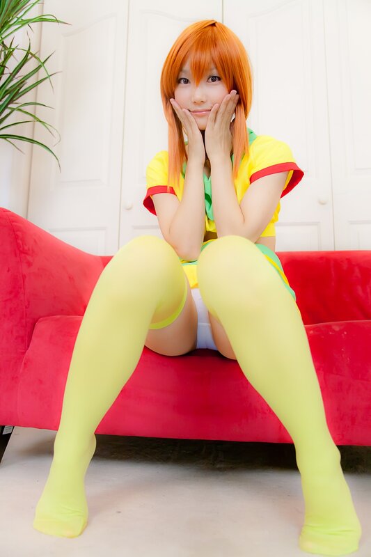 Person in Cosplay — Yellow, Playful, Photograph, Red Couch